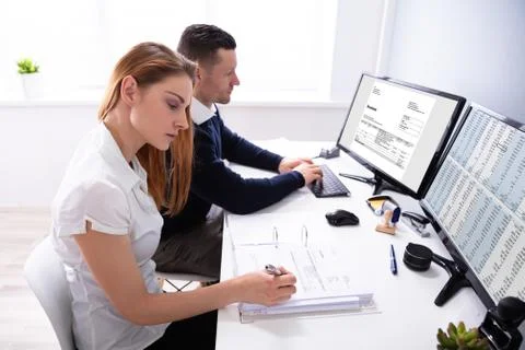 Auditors Working On Computer With Invoice Stock Photos