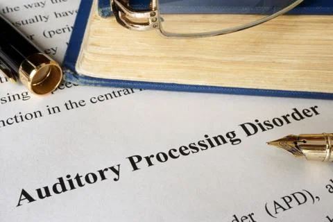 Auditory processing disorder APD on a sheet on an office table. Stockfoto's
