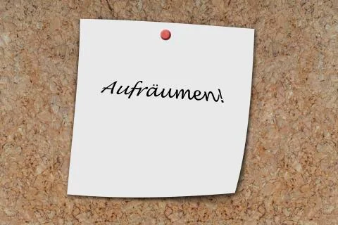 Aufräumen written on a memo Stock Photos