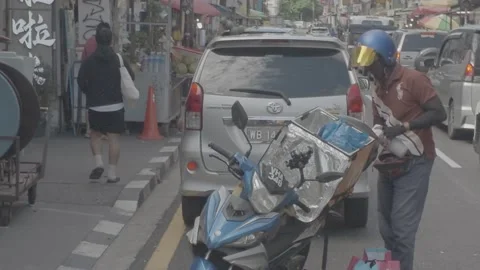AUG 16.2026.MALAYSIA.The courier is packing a parcel. Stock Footage 344011017