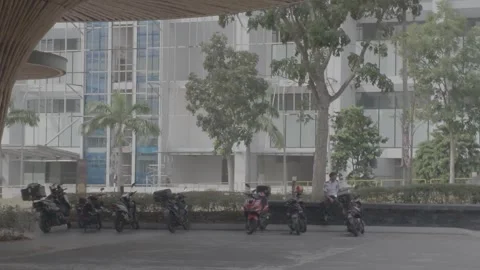 AUG 16.2026.MALAYSIA.A security guard sitting next to a motorcycle. Stock-Footage 344011102