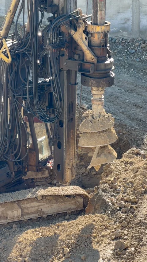 Auger drilling machine cutting ground on construction site shows drilling Stock Footage 329277914