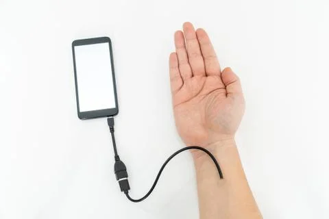 Augmented human hand connected to a smartphone via usb cable and transferring Stock Photos