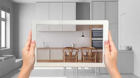 Augmented reality concept. Hand holding tablet with AR application used to .. Illustrazione stock