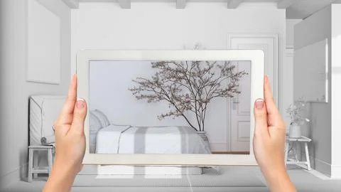 Augmented reality concept. Hand holding tablet with AR application used to .. Stock Illustration