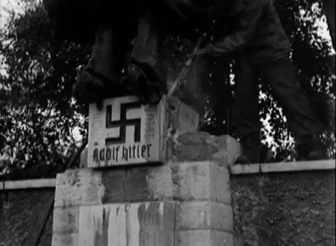 AUGSBURG - 1945: Eagle removal - Soldiers dismantle an eagle monument Stock Footage 344495790