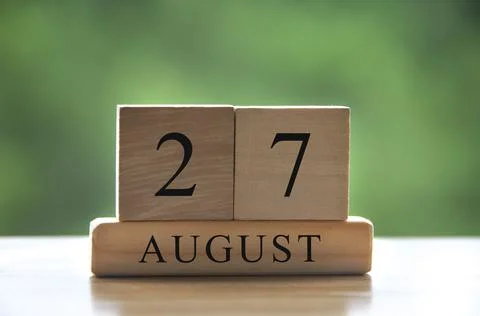 August 27 calendar date text on wooden blocks with blurred background park. Stock Photos