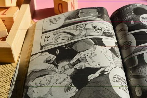 August 31, 2023, Close-up of an open comic book with bokeh background. Wada.. Stock Photos