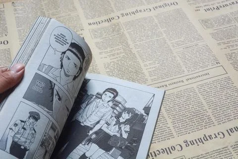 August 31, 2023, Close-up of an open comic book with bokeh background. Wada.. Stock Photos