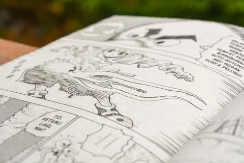 August 31, 2023, Close-up of an open comic book with bokeh background. Wada.. Stock Photos