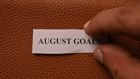 August Goals Planning Message on Brown Leather Flat Lay Stock Footage 336832757