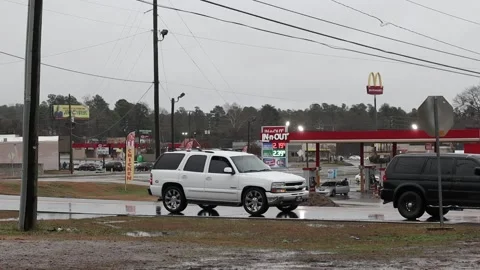 Augusta, Ga USA - 1 31 21: Urban landscape gas prices 2.19 - cars traffic and Stock Footage 148950801