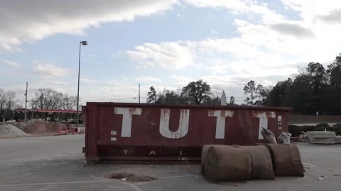 Augusta Georgia pan of construction materials and a waste dumpster Stock Footage 149052260