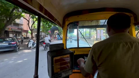 Auro driver navigates through the city traffic of India during the day Stock Footage 337458368