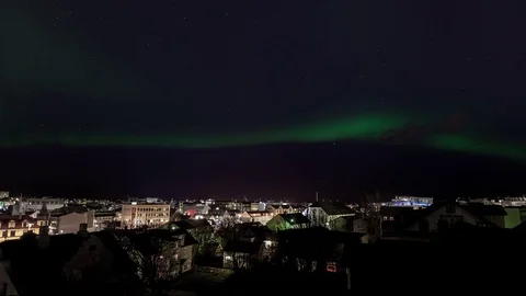 Aurora borealis and clouds over the cityscape at night Stock Footage 73012067
