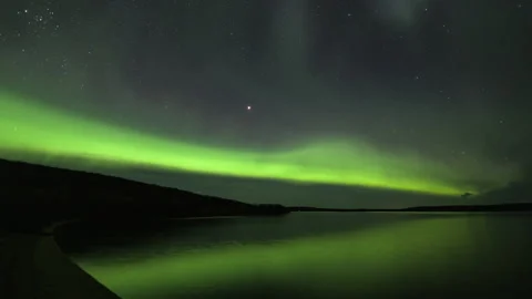 Aurora Borealis arc over a sandy bay with Mars Stock Footage 250294661