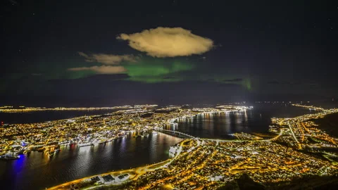 Aurora Borealis in cloudy sky over Tromso Stock Footage 250455282
