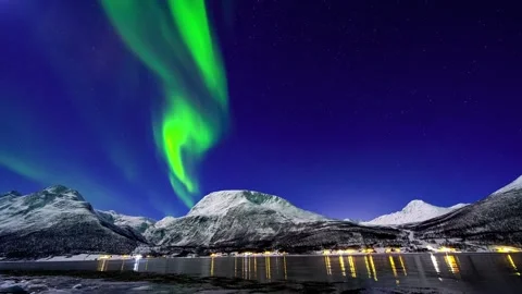 Aurora borealis dancing above snowy mountains and fjord lights night sky time Video stock 345656164