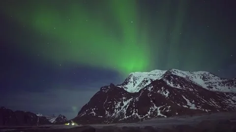 Aurora Borealis Flows Over Snowy Mountains in Arctic Norway with Green and Viole Stock Footage 308970357