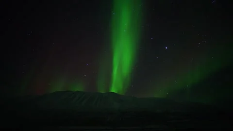 Aurora Borealis Moving Beneath a Starry Night Sky Over Mountain In Iceland Stock Footage 293136462