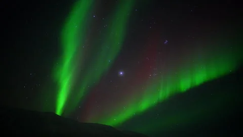 Aurora Borealis Moving Beneath a Starry Night Sky Over Mountain In Iceland Stock Footage 293136878