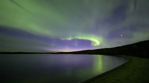 Aurora Borealis over a sandy bay Stock Footage 250295441