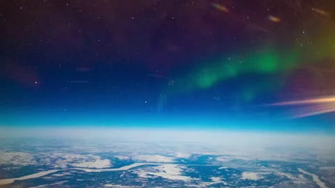 Aurora Borealis from a plane over the earth Stock Footage 154862392
