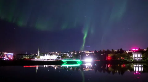 Aurora borealis Reykjavik city traffic bridge pond water reflection realistic 4k Stock Footage