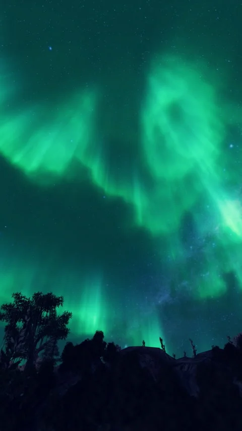 Aurora Borealis timelapse over snowy mountain range, panning, vertical video Stock Footage 333134353