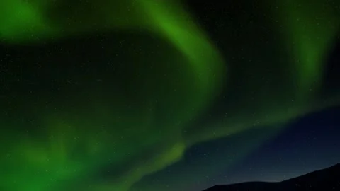 Aurora at night in a clear sky against the foreground of a dark plain. Stock Footage 142937788