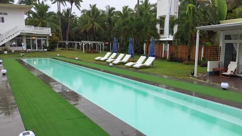AURORA, PH - L sirene beach resort cottage facade and swimming pool area on Stock Footage 346928565