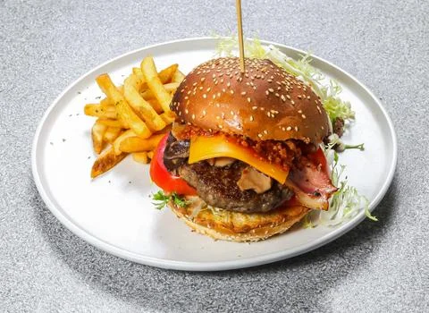 Aussie Beef Burger include cheese slice, tomato, cabbage and chilli sauce w.. Stock Photos