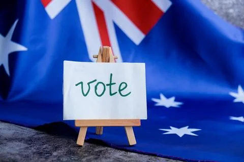 Aussie flag near text VOTE for electoral campaigns. Minimalist patriotic message Photos