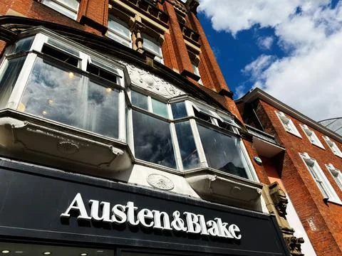 Austen and Blake storefront and historic red brick building with bay window.. Stock Photos