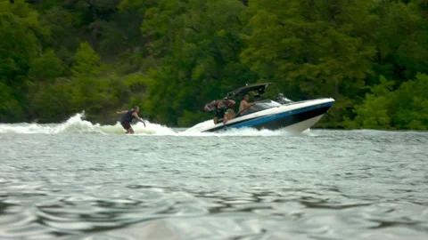 Austin, Texas - 9/2/2018: Speedboat pulling wakeboarder on Lake Travis Stock Footage 98043582
