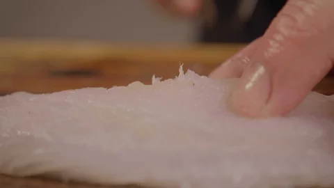 Australasian Snapper being prepared for cooking - Pin bones being removed Video stock 129798945