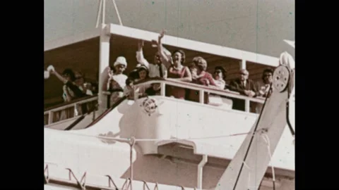 Australia 1960s: Men pull rope on boat ropes at boat dock. People stand on Stock Footage 239266324