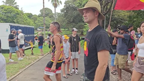 AUSTRALIA DAY PROTEST MAN WAVES ABORIGINAL FLAG SUPPORTING INDIGENOUS RIGHTS Stock Footage 262847563
