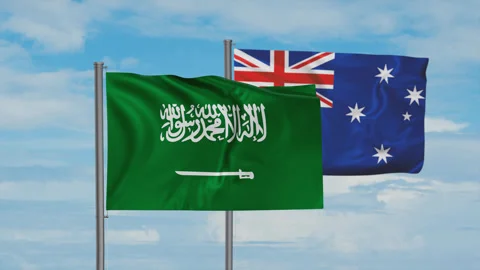 Australia flag and Saudi Arabia flag waving together on blue sky, looped video, Stock Footage 244061663