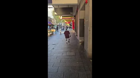 Australia: Humanoid robot strolls through city centre to buy shoes for ch... Stock Footage 344968367