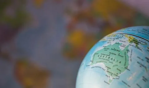 Australiamap on a globe with earth map in the background. Stock Photos