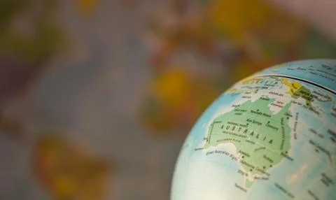Australiamap on a globe with earth map in the background. Stock Photos