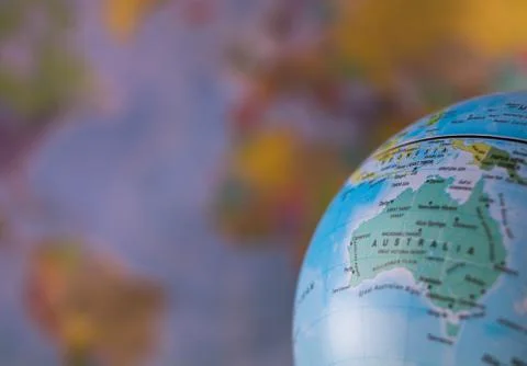 Australiamap on a globe with earth map in the background. Stock Photos
