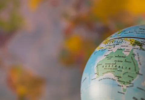 Australiamap on a globe with earth map in the background. Stock Photos