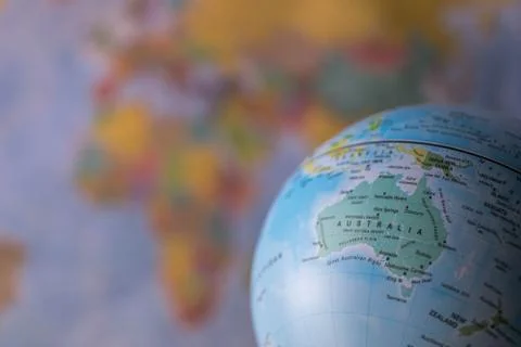 Australiamap on a globe with earth map in the background. Stock Photos