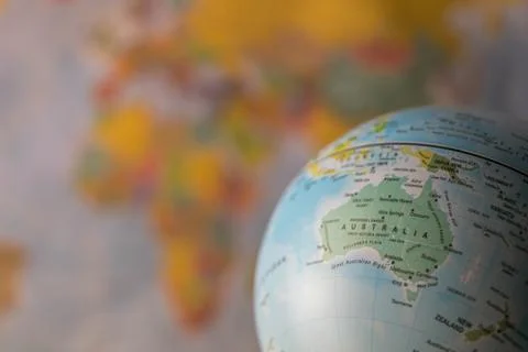 Australiamap on a globe with earth map in the background. Stock Photos