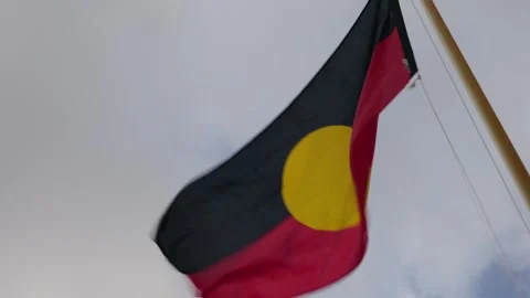 Australian Aboriginal flag on flagpole on a windy, overcast day. Clip 3 Stock Footage 284417783