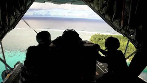 Australian Air Force drop cargo on parachute from C-130J Hercules over Guam Stock Footage 83350983
