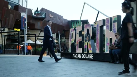 Australian commuters pass Perth sign in the city 6K Stock Footage 312241162