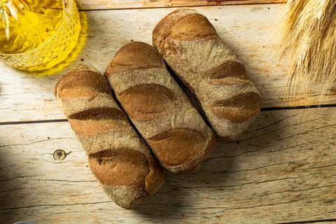 Australian dark bread top view over a wooden table Stock Photos